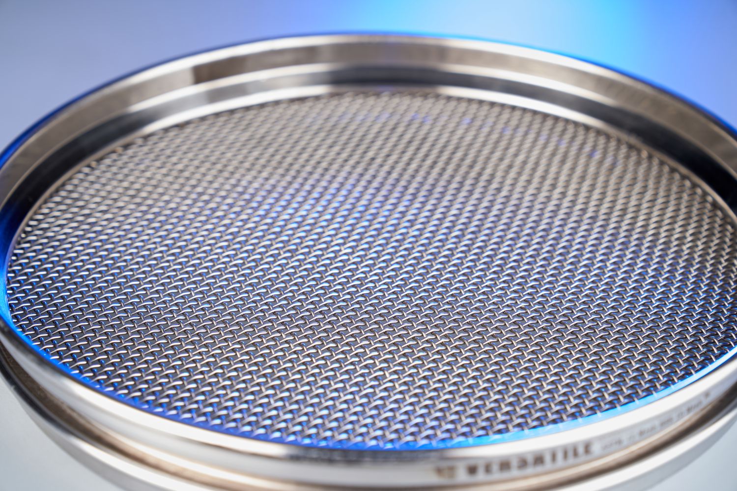 Close detail of tensioned woven wire mesh under inspection